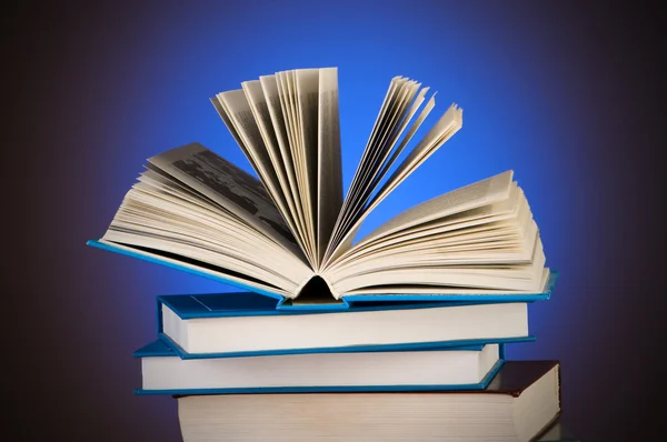 stock image Stack of books against gradient background