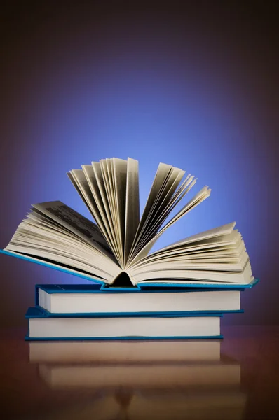 Stack of books against gradient background — Stock Photo, Image