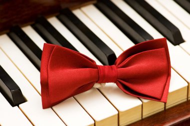 Red bow tie on the piano keys clipart