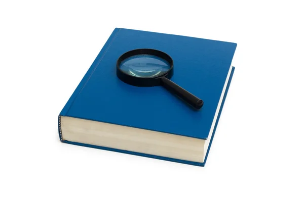 Blue book and magnifying glass on the white — Stock Photo, Image