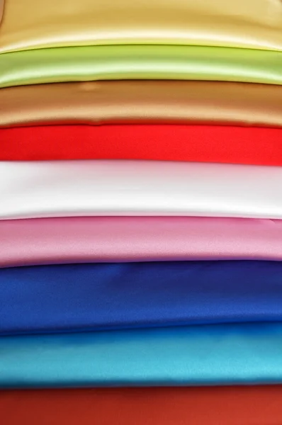 stock image Stack of satin fabric of various colours