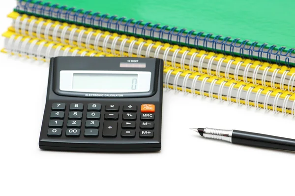 Calculadora, cuadernos en espiral y pluma aislados en blanco —  Fotos de Stock