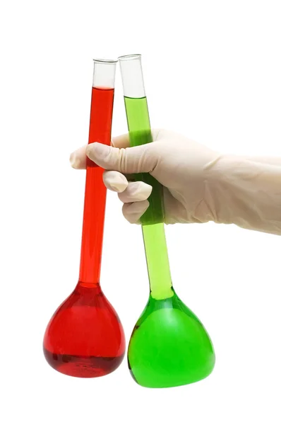 Hand holding red and green tubes isolated on white — Stock Photo, Image