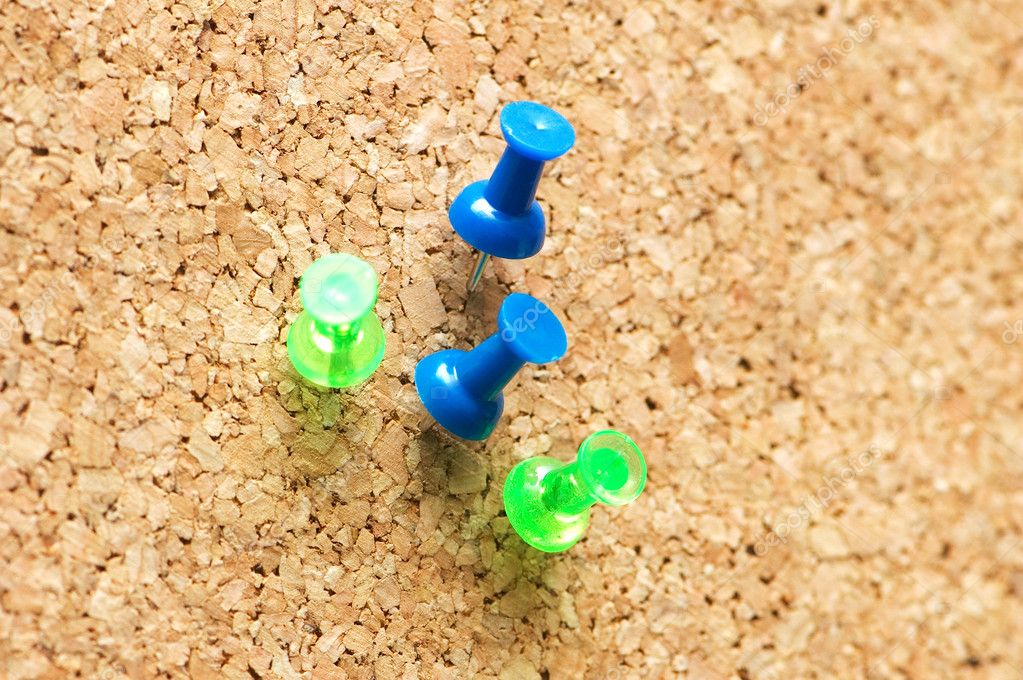 Corkboard with blue and green thumbtacks — Stock Photo © Elnur_ 4359581