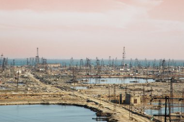 Many oil derricks on the shore near Baku, Azerbaijan clipart