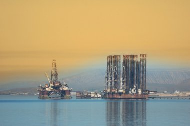 Two offshore rigs at Caspian shore near Baku clipart