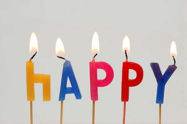 Brandende kaarsen met het woord "happy" — Stockfoto