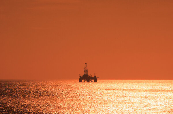 Offshore oil rig during sunset in Caspian sea