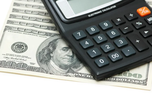 Dólares e calculadoras isoladas no branco — Fotografia de Stock