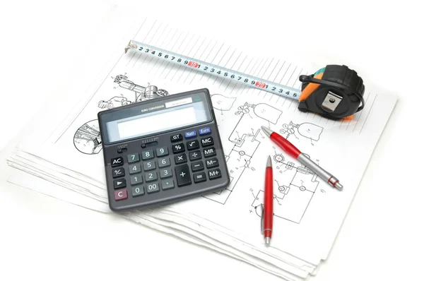 Calculator and pencils over the engineering drawings — Stock Photo, Image