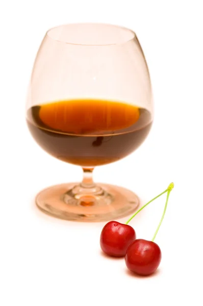 Glas vin och två körsbär på vit — Stockfoto