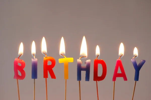 Burning candles with the word "Birthday" — Stock Photo, Image