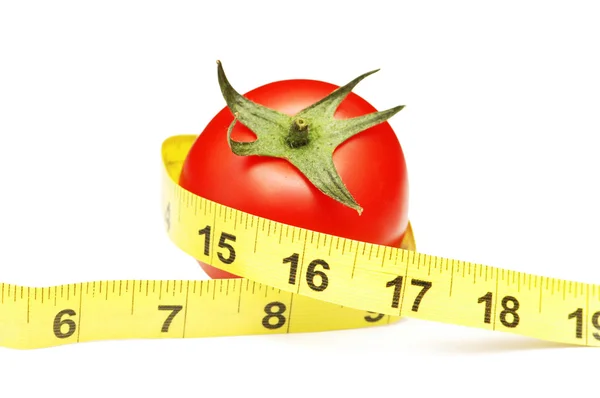 Томат и измерительная лента, иллюстрирующие концепцию диеты — стоковое фото