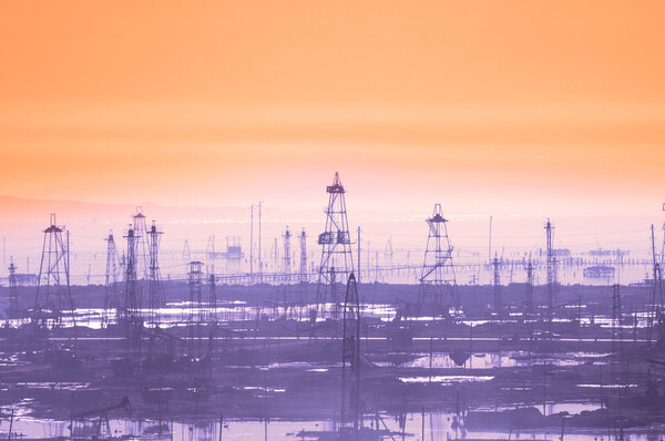 Oil derricks on early morning - Caspian see near Baku