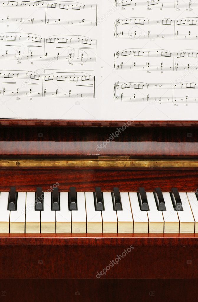 Piano with black-white keys and musical notes