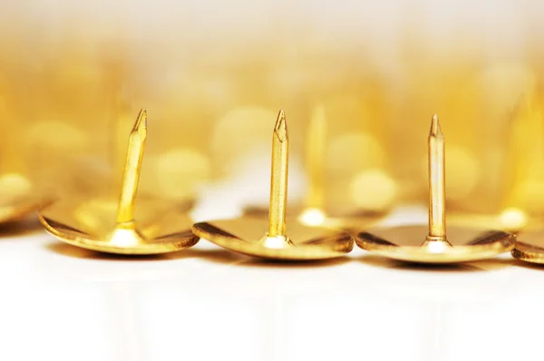 Golden pins isolated on the white background — Stock Photo, Image