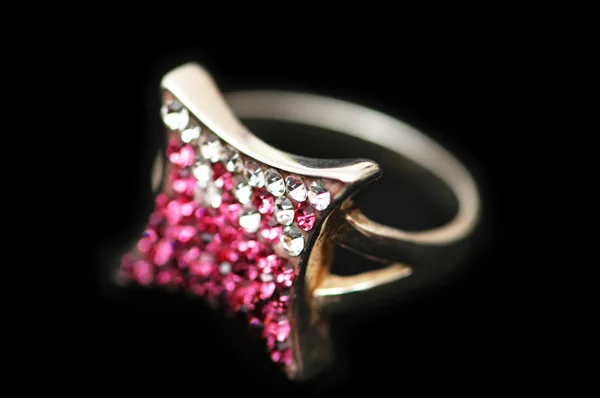Juwelenring mit weißen und rosa Steinen isoliert auf schwarz — Stockfoto