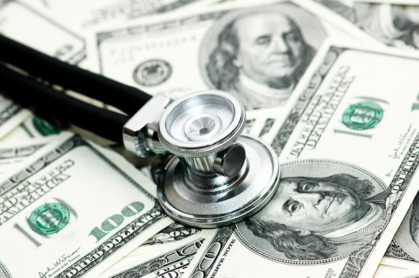 Medical concept - stethoscope over the dollar bills — Stock Photo, Image