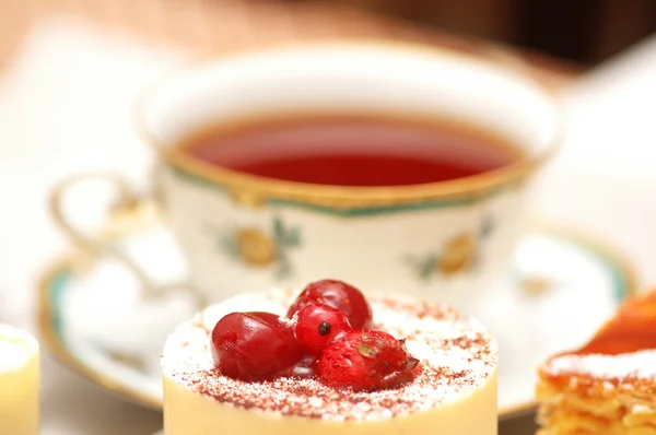 Close up of fruit cake and cup at the background — Stock Photo, Image