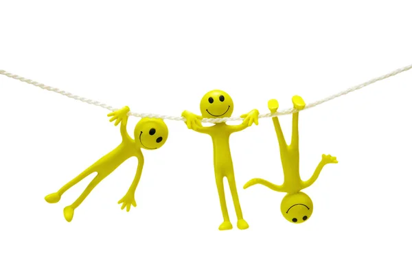 Three smiley actobats on the rope isolated on white — Stock Photo, Image