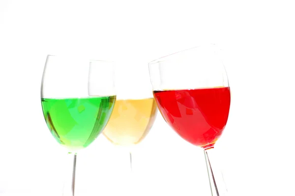 Tre liquori colorati isolati su bianco - riflessi deliberati — Foto Stock