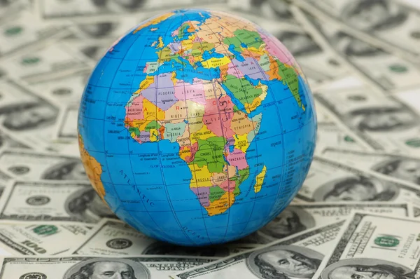 Globe isolated on the background of dollar bank notes — Stock Photo, Image