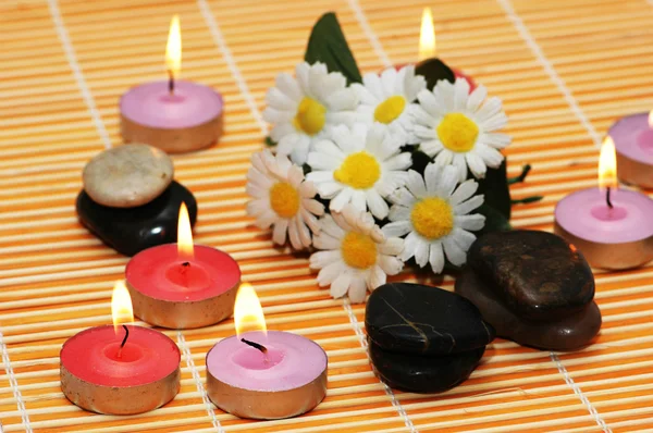 Flowers, stones and candles for spa treatment — Stock Photo, Image