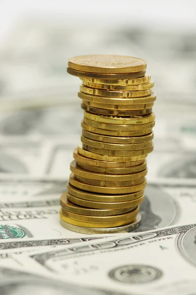 Stack av mynt över hundra dollarn räkningar — Stockfoto