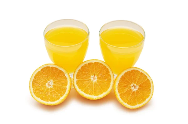 Напіврізані апельсини та свіжий апельсиновий сік — стокове фото
