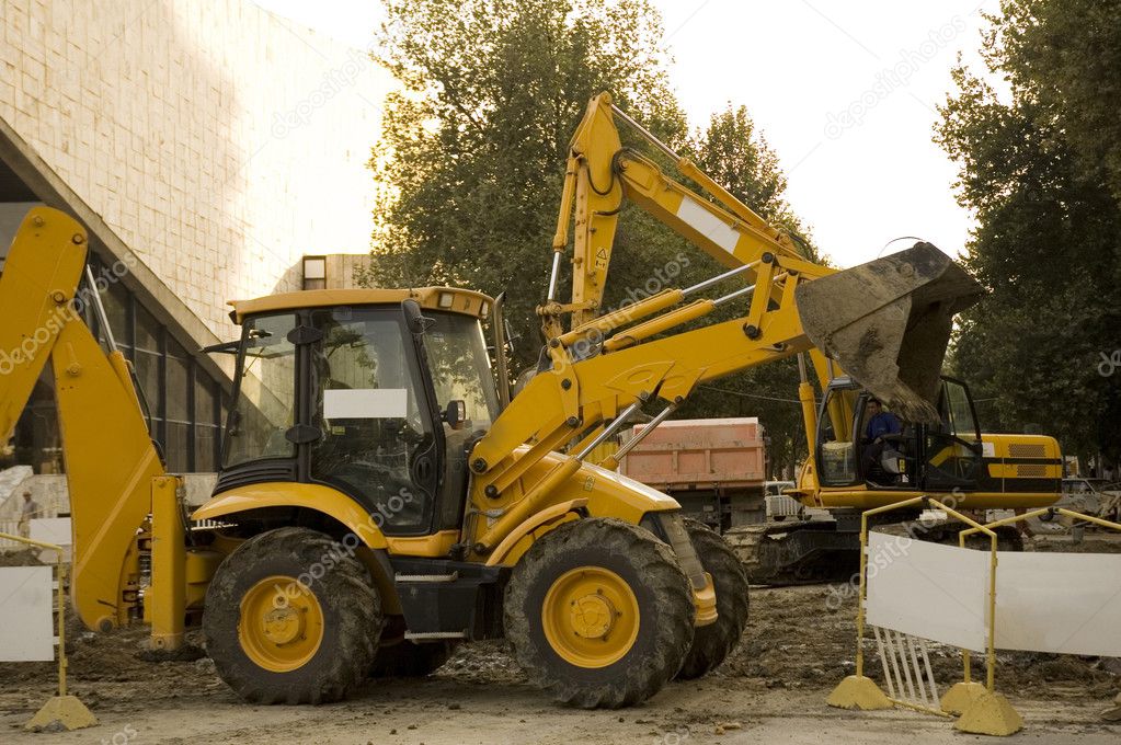 Construction vehicles on the site digging a trench Stock Photo by ...