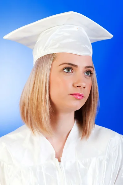 Glad graduate mot färgstarka bakgrund — Stockfoto