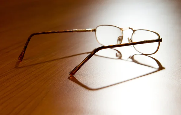 Reading glasses on the wooden background — Stock Photo, Image