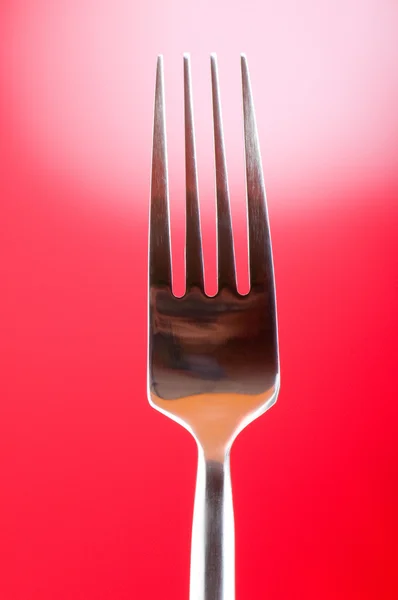 Silver fork against gradient color background — Stock Photo, Image