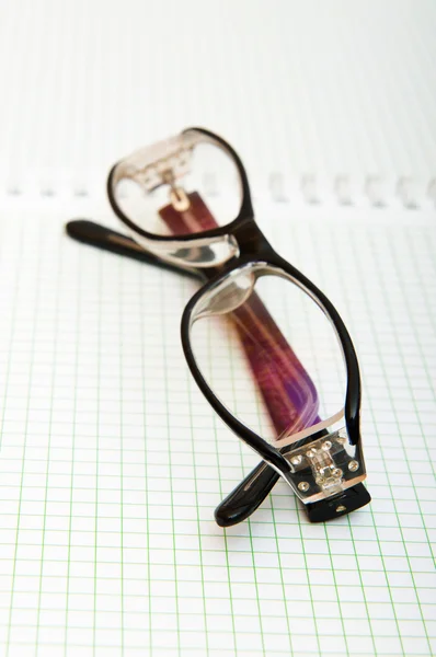 Reading glasses on the black page — Stock Photo, Image