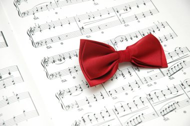 Bow tie on sheet of printed music clipart