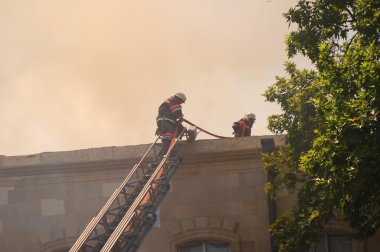 Firemen at the roof during fire clipart