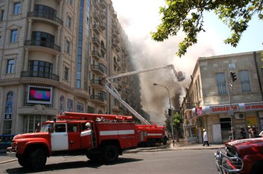 Firetrucks and firefighters on a boom clipart