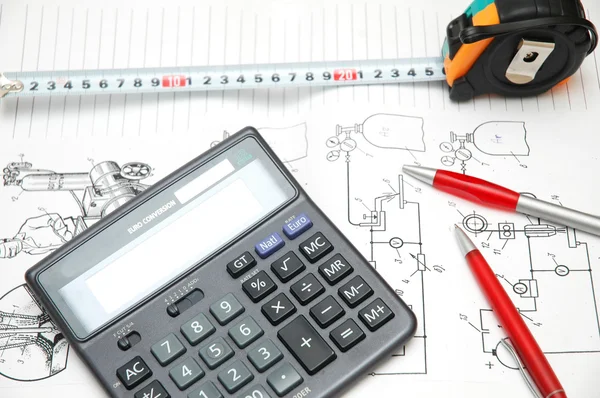 Rysunki projektowe, kalkulator, długopisy i taśma pomiarowa — Zdjęcie stockowe