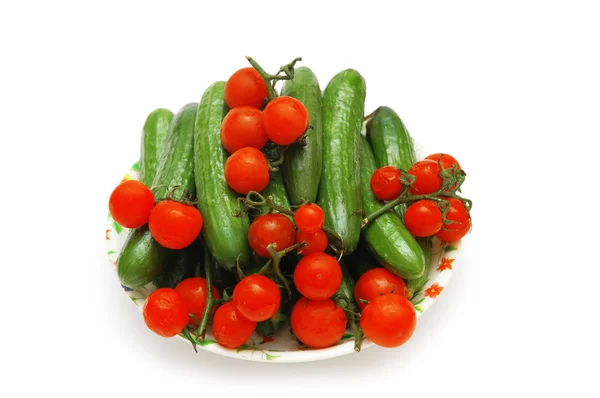 Plate with cucumbers and tomatoes isolated on white — Stock Photo, Image