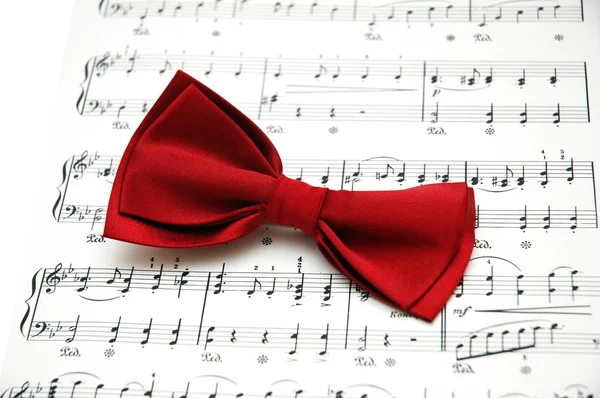 Bow tie on sheet of printed music — Stock Photo, Image