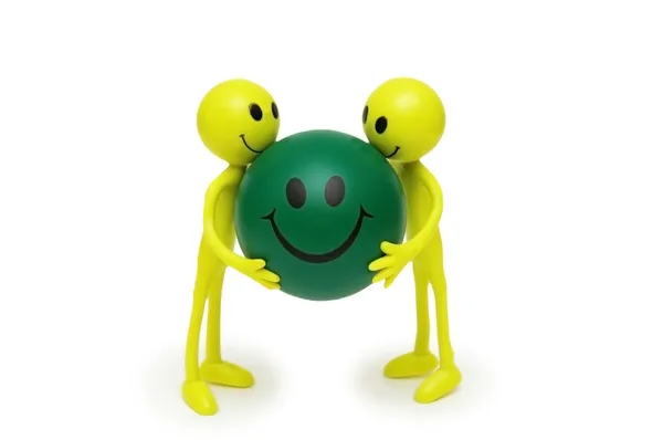 Zwei Smilies halten Ball mit Lächeln isoliert auf weiß — Stockfoto