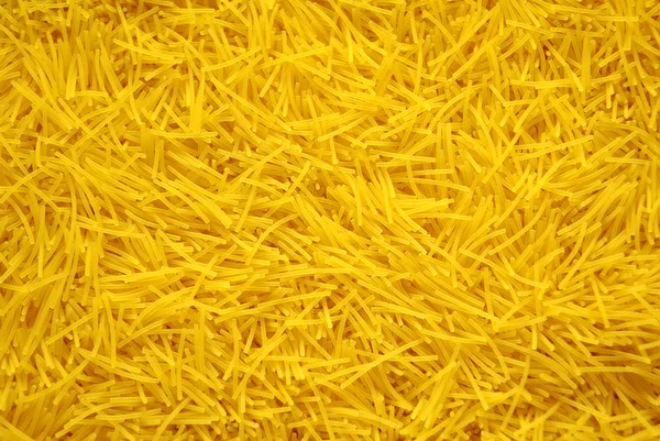 Uncooked pasta as a background — Stock Photo, Image