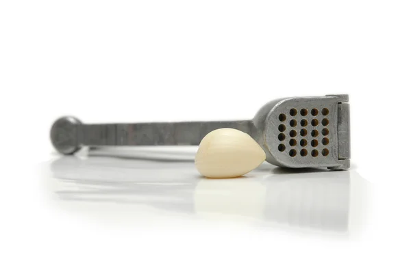 Garlic clove and crusher isolated on white — Stock Photo, Image
