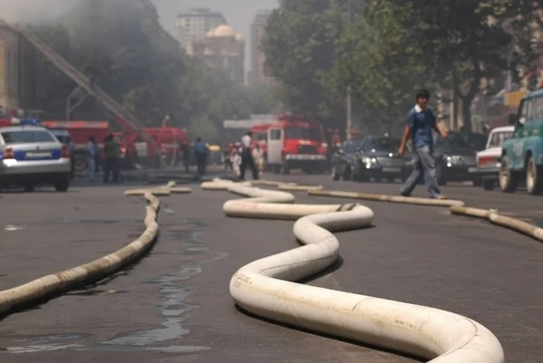 Fire hoses stretching across the street during fire