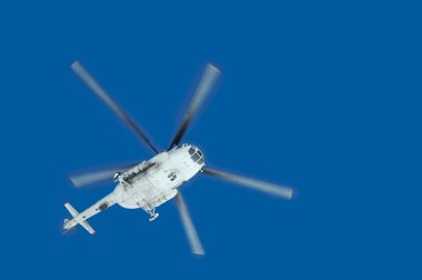 Helicopter in the air across clear sky clipart