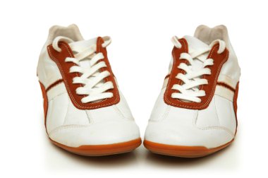 Pair of white trainers isolated on white clipart