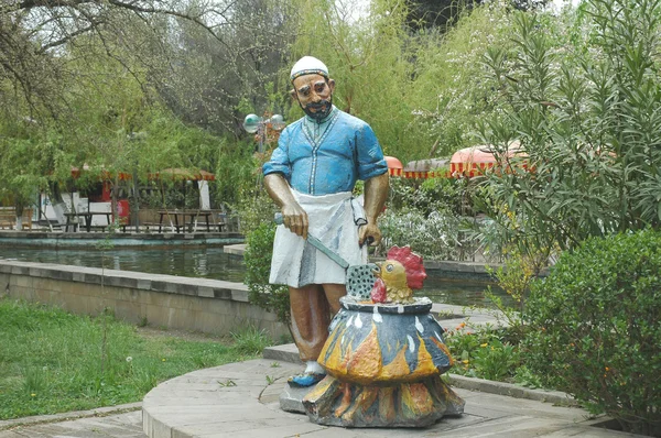 stock image Figure of a man cooking a cock in a pot