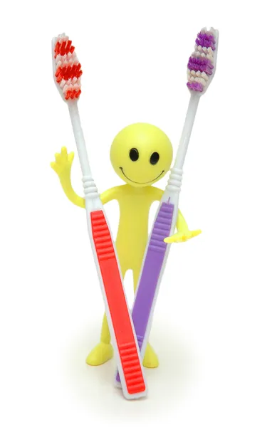 Toothbrushes and figure of smiley — Stock Photo, Image