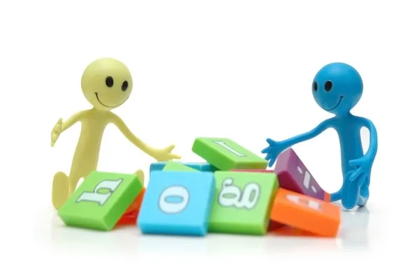 Two smilies playing with alphabet letters — Stock Photo, Image