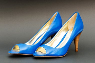 Fashion concept with blue woman shoes on high heels clipart